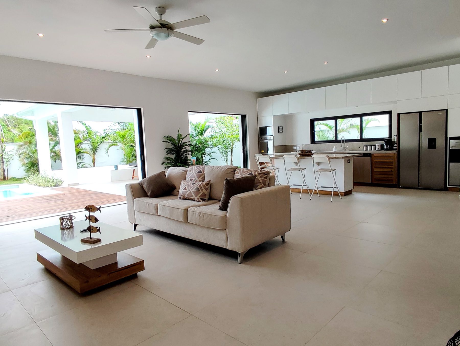 Villa Way, the living room, open to the pool and the kitchen